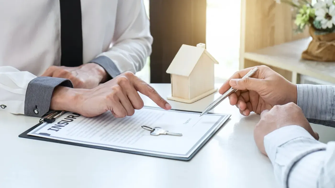 Two people in an office reviewing insurance paper work