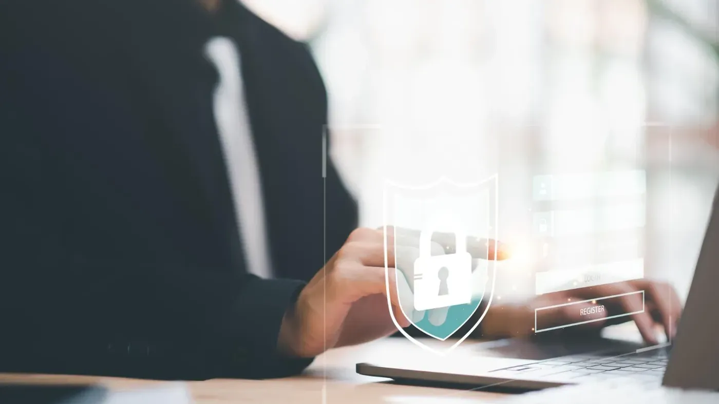 man typing on computer with security