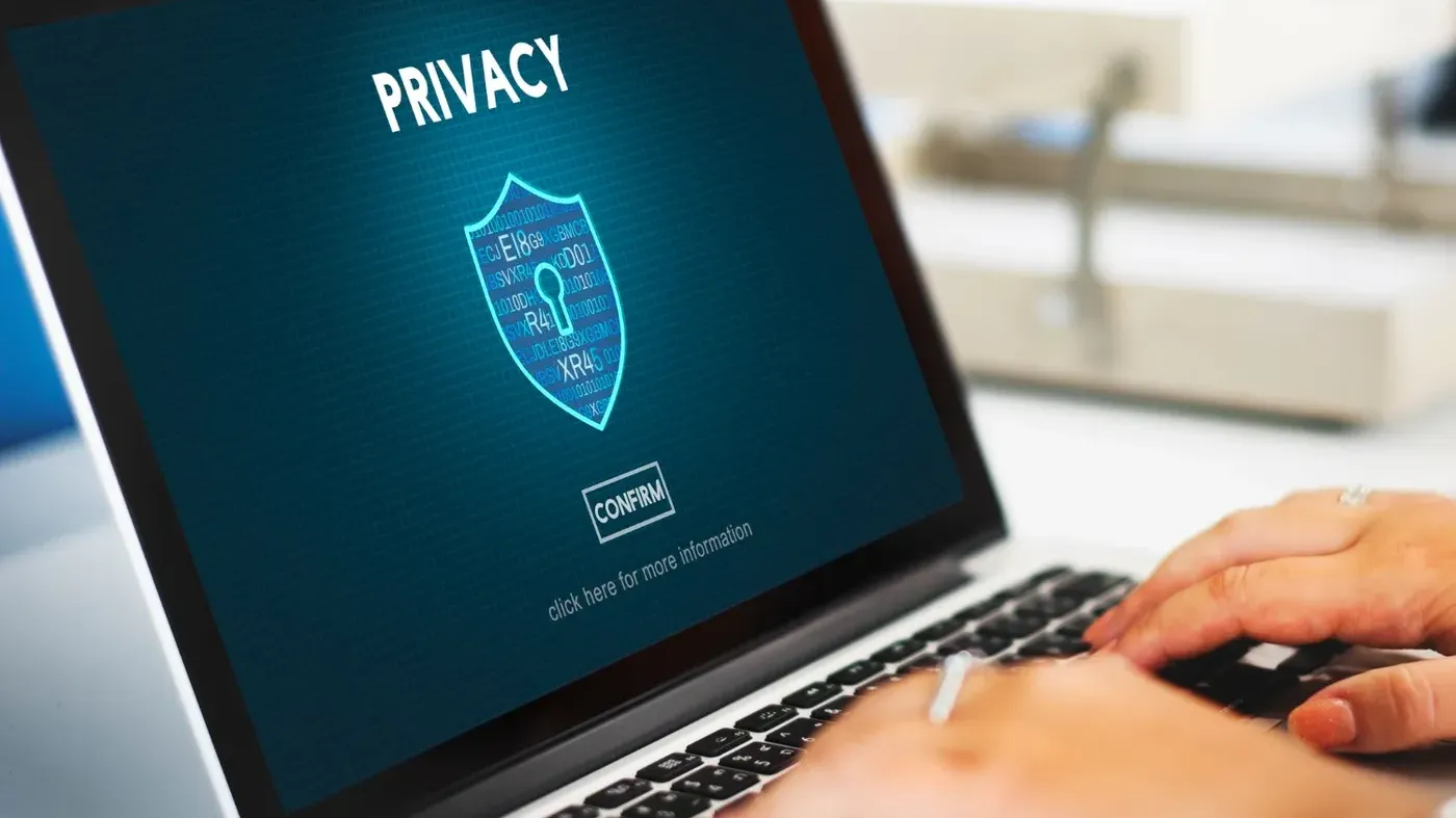 person typing on computer that says privacy