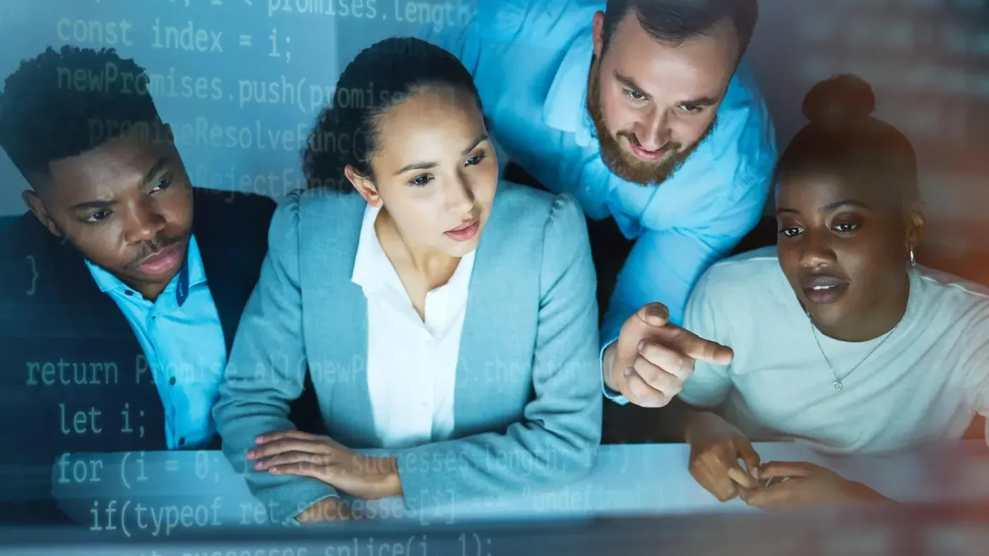 The same diverse business professionals now with observant and calm expressions joined by an IT specialists huddled around a computer monitor with a blue code overlay, indicating a successful cybersecurity incident response.
