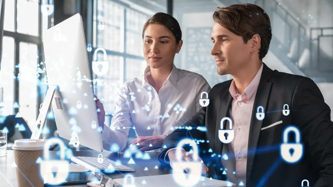 Man and Woman looking at a computer screen with floating padlocks