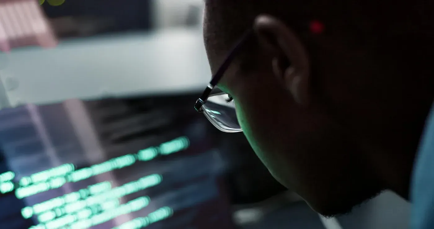 man with glasses looking at computer