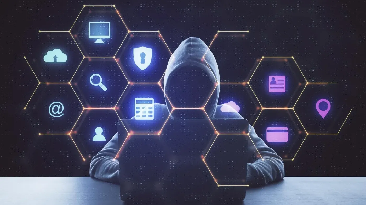 A silhouette of a hacker in a hoodie using a laptop, surrounded by glowing hexagonal icons representing various cyber crimes including digital security, cloud storage, location, hacking, and finance.