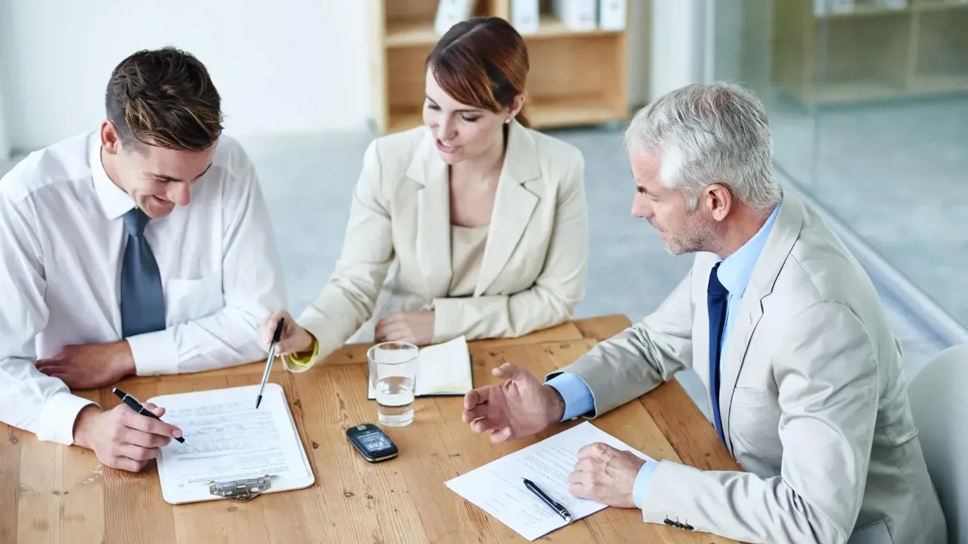 three insurance workers talking
