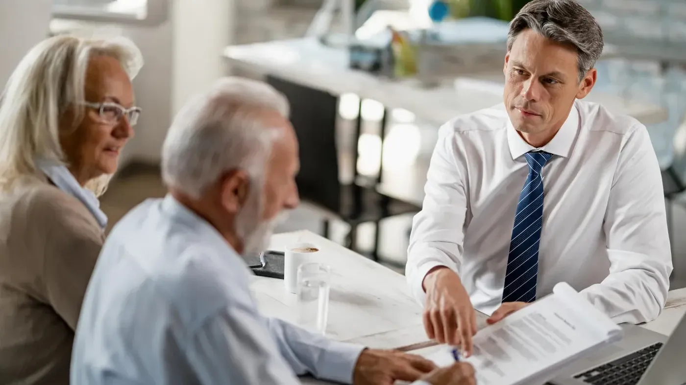 A business man showing papers to a couple