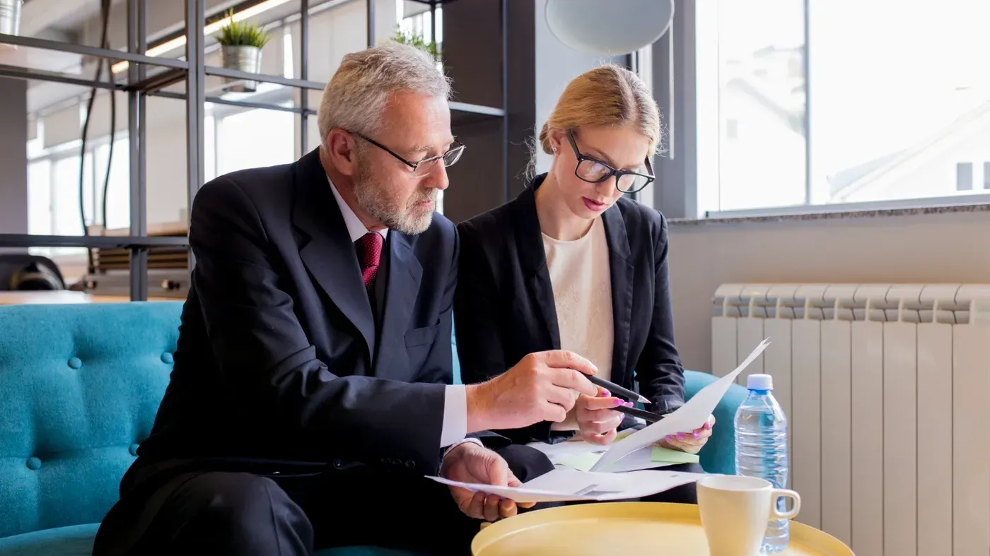 Liabilities insurance for business represented by a man and a women looking over a sheet of paper together