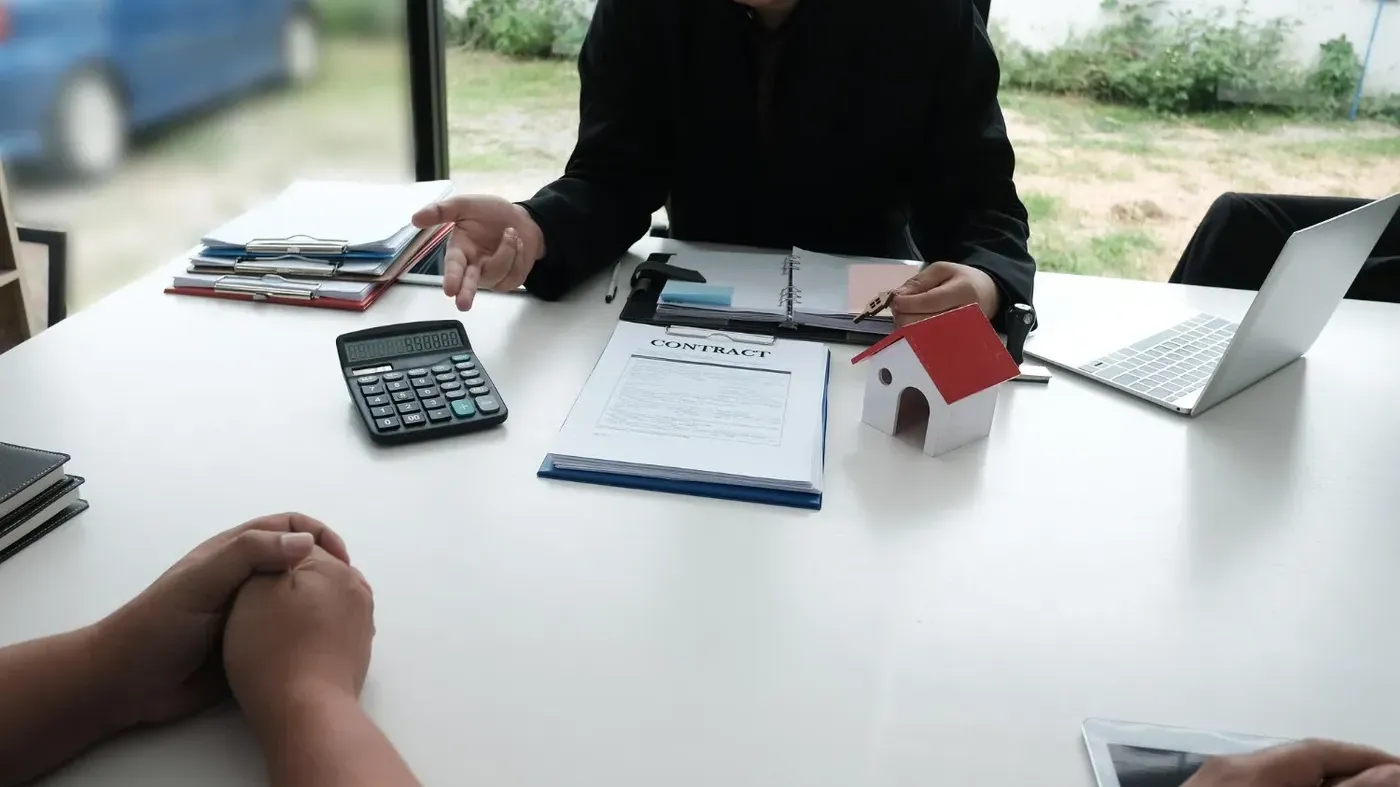 people at a desk discussing insurance