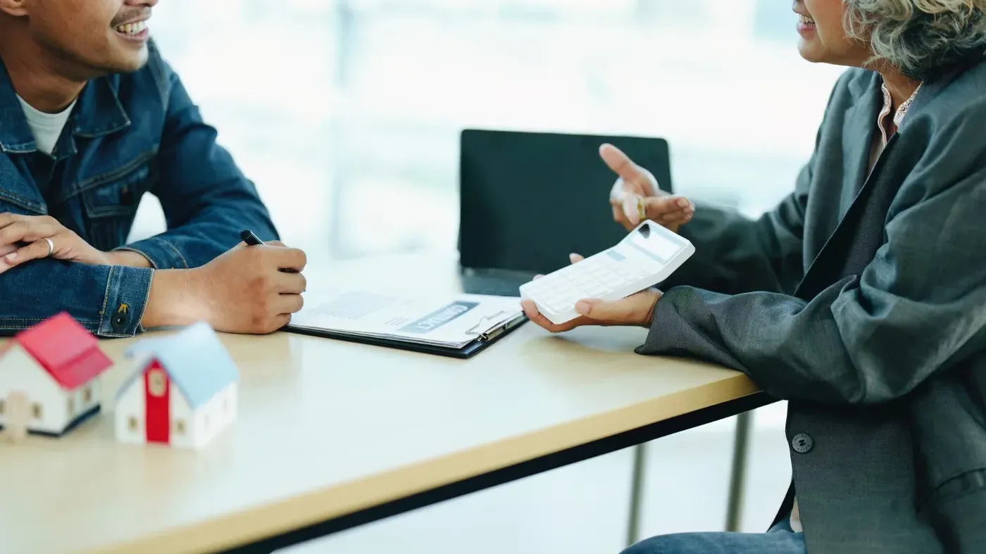 man and woman discussing insurance at a desk