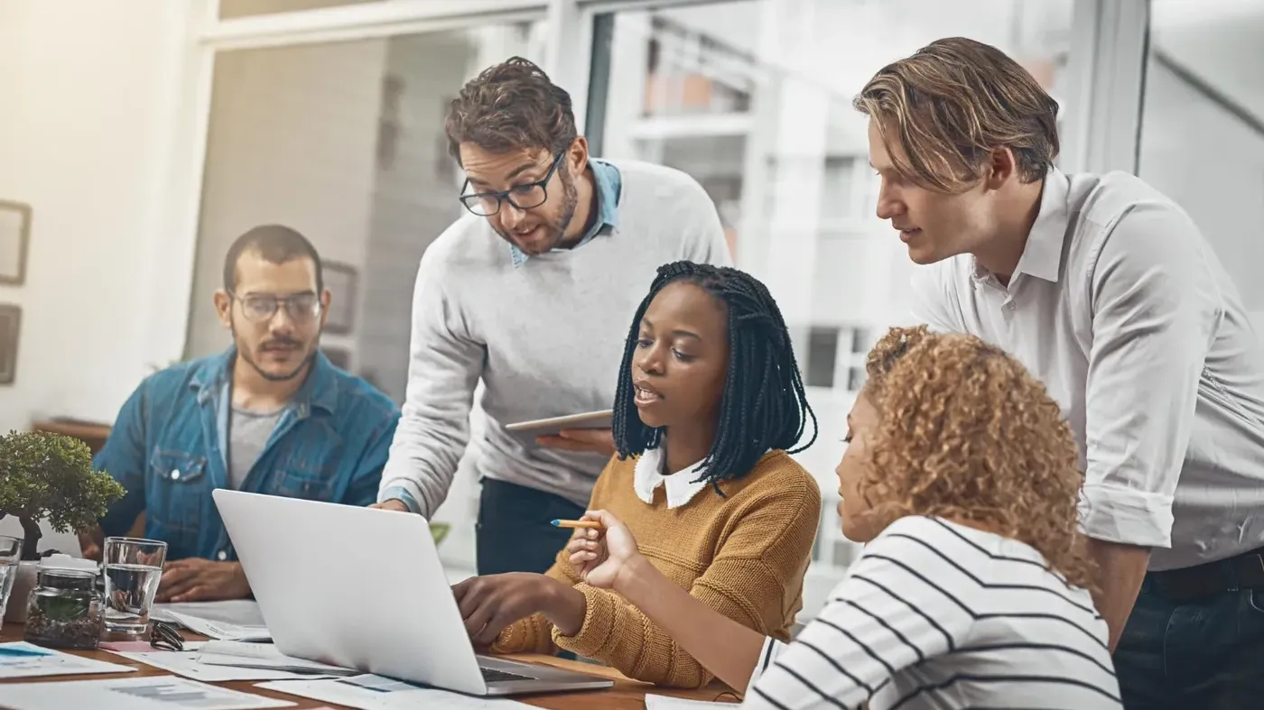 Small business owner review quotes with her team in an office